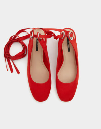 Red high heel shoes with a tied detail
